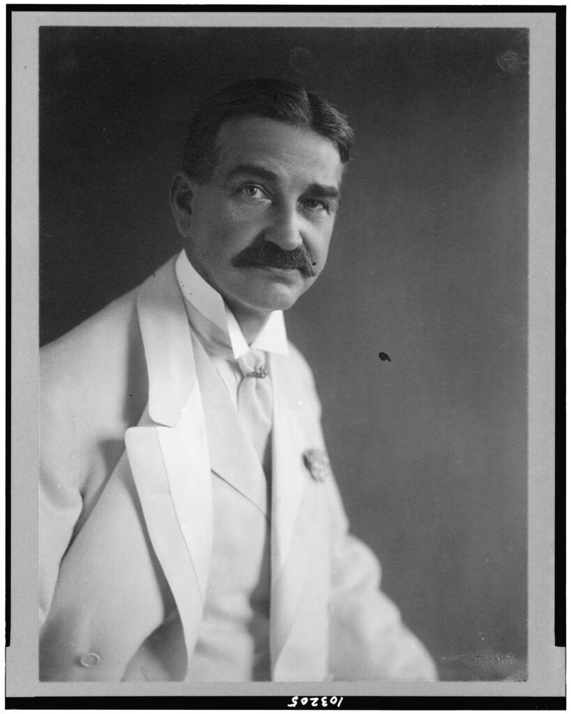 Black-and-white 1908 portrait photograph of L. Frank Baum in a light-coloured suit, facing slightly right